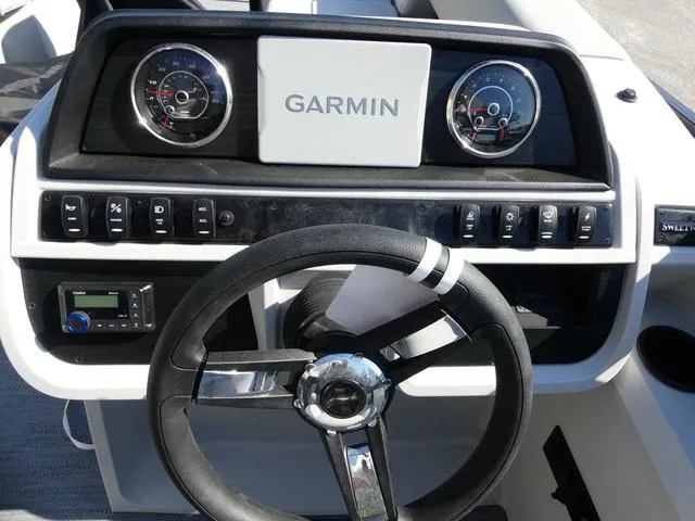 Slide: The Image of 2025 Godfrey Pontoons Sweetwater 2286 SFL dashboard with Garmin display and steering wheel. - 10