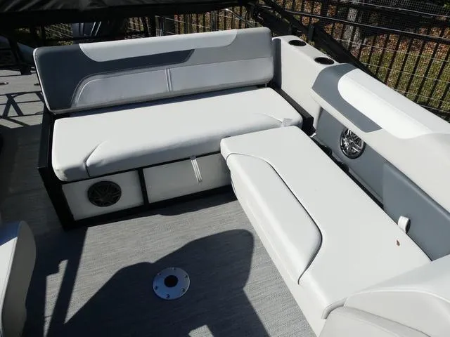 Slide: The Image of 2025 Godfrey Pontoons Sweetwater 2286 SFL interior with white seating and speaker system. - 13