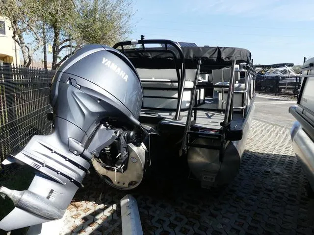 Slide: The Image of 2025 Godfrey Pontoons Sweetwater 2286 SFL with Yamaha outboard motor, parked outdoors. - 6