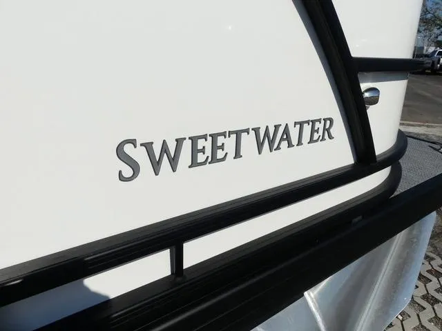 Slide: The Image of 2025 Godfrey Pontoons Sweetwater 2286 SFL boat, close-up of logo on white exterior. - 8