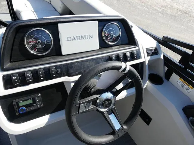 Slide: The Image of 2025 Godfrey Pontoons Sweetwater 2286 SFL dashboard with Garmin navigation and steering wheel. - 9