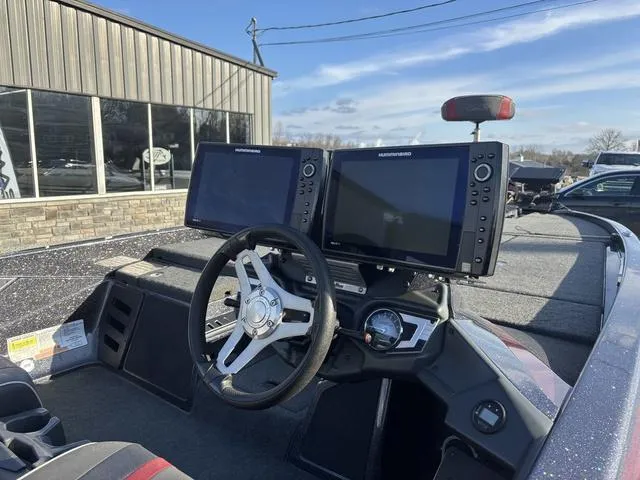 Slide: The Image of 2018 Skeeter FX21 LE boat dashboard with dual fish finders and steering wheel. - 6