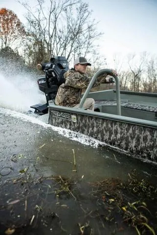 Slide: The Image of Man driving 2025 Edge Duck Boats HPSD 756DB in shallow water, surrounded by trees. - 10