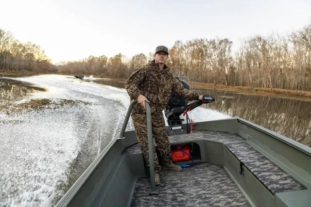 Slide: The Image of Man steering 2025 Edge Duck Boats HPSD 756DB on a calm river. - 12