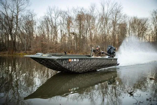Slide: The Image of 2025 Edge Duck Boats HPSD 756DB speeding on a calm river, surrounded by bare trees. - 15
