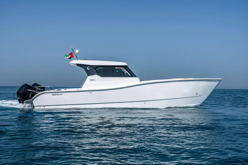 Slide: The Image of 2026 SilverCAT 34HT boat cruising on open water under clear blue sky. - 10
