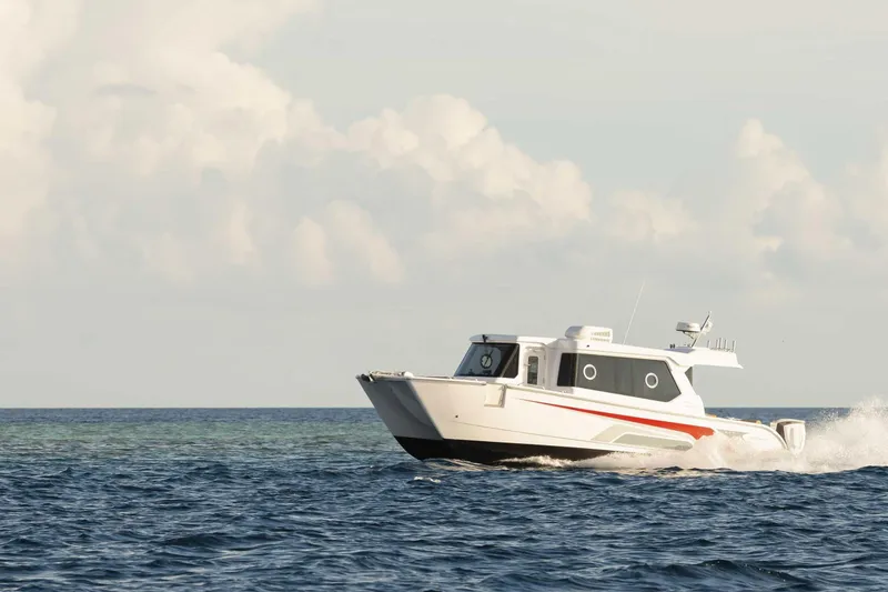 Slide: The Image of SilverCAT 34LUX 2026 model cruising on open sea under cloudy sky. - 2