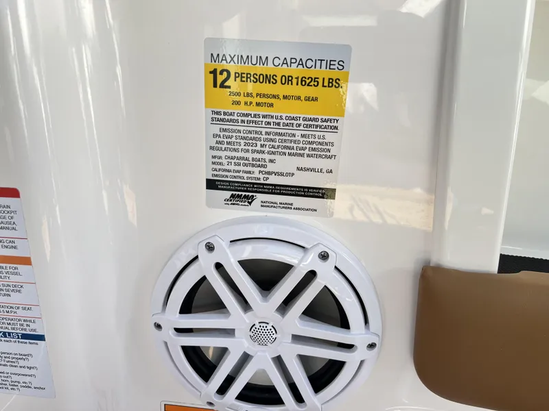 Slide: The Image of 2023 Chaparral 21SSi OB SPORT capacity label, speaker detail, maximum 12 persons or 1625 lbs. - 10