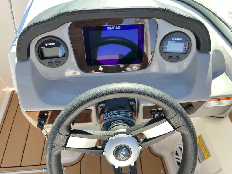 Slide: The Image of 2023 Chaparral 21SSi OB SPORT dashboard with Simrad display and Yamaha gauges. - 11