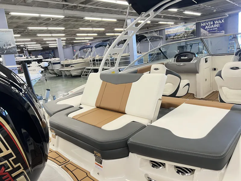 Slide: The Image of 2023 Chaparral 21SSi OB SPORT boat interior with stylish seating in a showroom. - 5