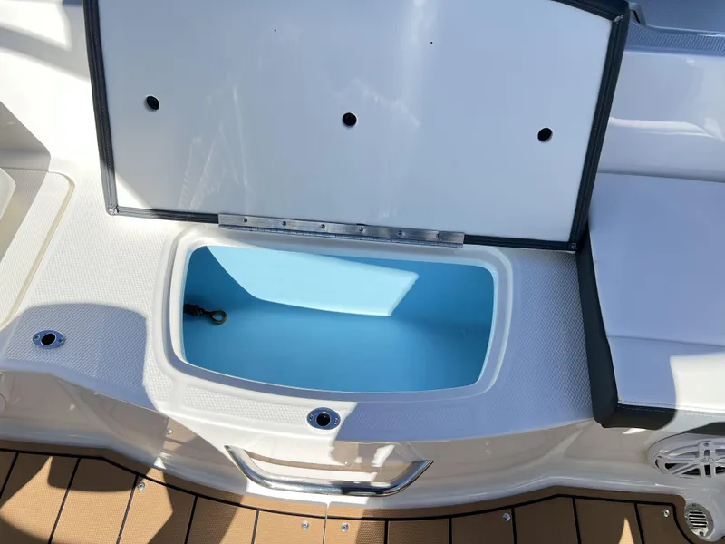 Slide: The Image of 2023 Chaparral 21SSi OB SPORT boat storage compartment with open lid. - 7