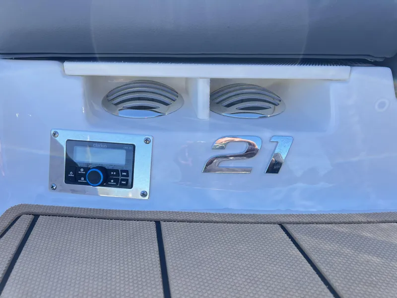 Slide: The Image of 2023 Chaparral 21SSi OB SPORT boat dashboard with stereo system and speaker vents. - 8