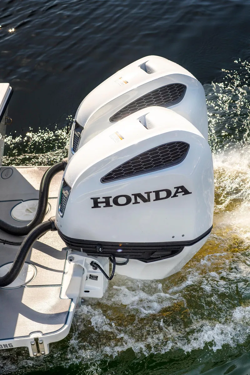 Slide: The Image of Twin Honda outboard motors on a 2003 Regulator 26 Forward Seating boat. - 13