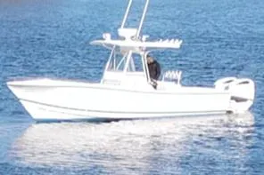 Slide: The Image of 2003 Regulator 26 Forward Seating boat on calm blue water. - 15