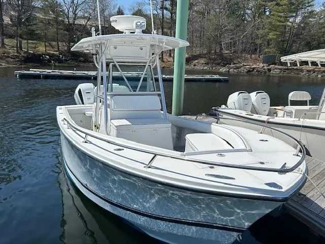 Slide: The Image of 2003 Regulator 26 Forward Seating boat docked on a calm lake. - 16
