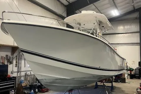 Slide: The Image of 2003 Regulator 26 Forward Seating boat in a storage facility. - 2