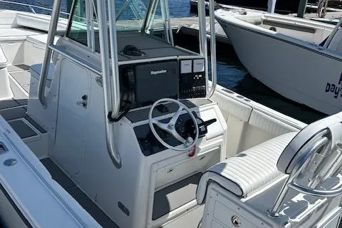 Slide: The Image of 2003 Regulator 26 Forward Seating boat interior with steering console and seating. - 21
