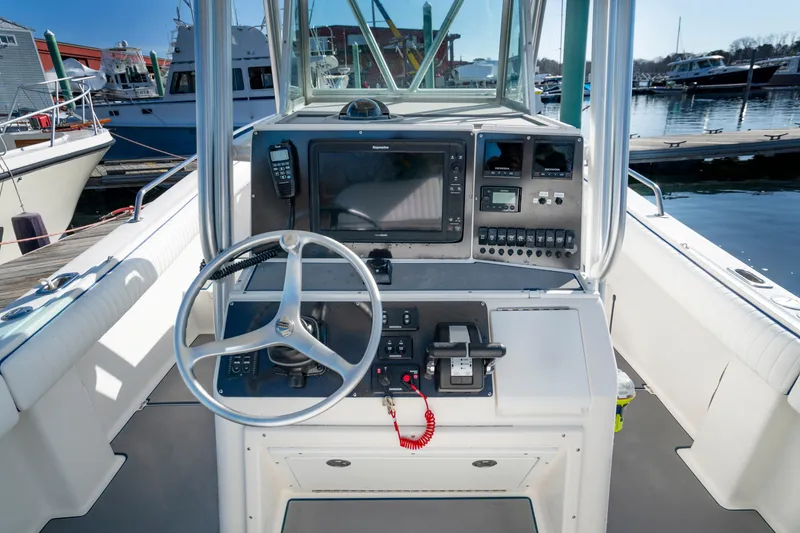 Slide: The Image of 2003 Regulator 26 Forward Seating boat console with steering wheel and navigation equipment. - 22