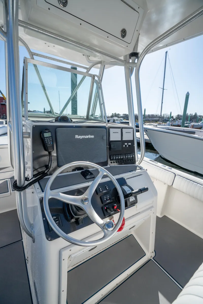 Slide: The Image of 2003 Regulator 26 Forward Seating boat console with steering wheel and navigation equipment. - 24