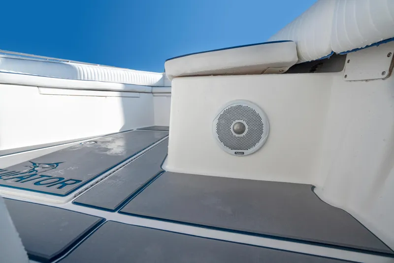 Slide: The Image of 2003 Regulator 26 Forward Seating boat interior with speaker and cushioned seating. - 25