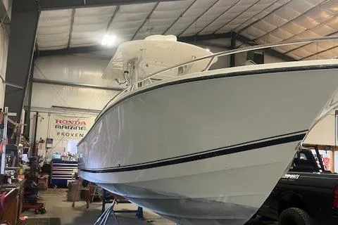 Slide: The Image of 2003 Regulator 26 Forward Seating boat in a workshop setting. - 29