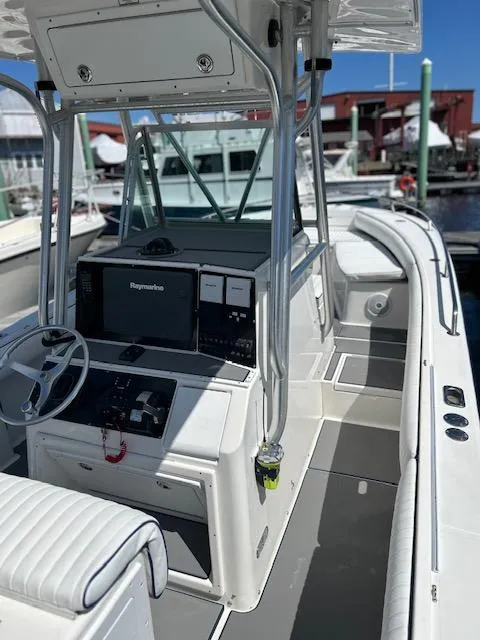 Slide: The Image of 2003 Regulator 26 Forward Seating boat with modern helm and spacious deck. - 5