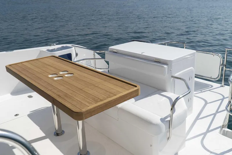 Slide: The Image of Luxurious SilverCAT 40LUX yacht deck with wooden table, white seating, and ocean view, 2026 model. - 10