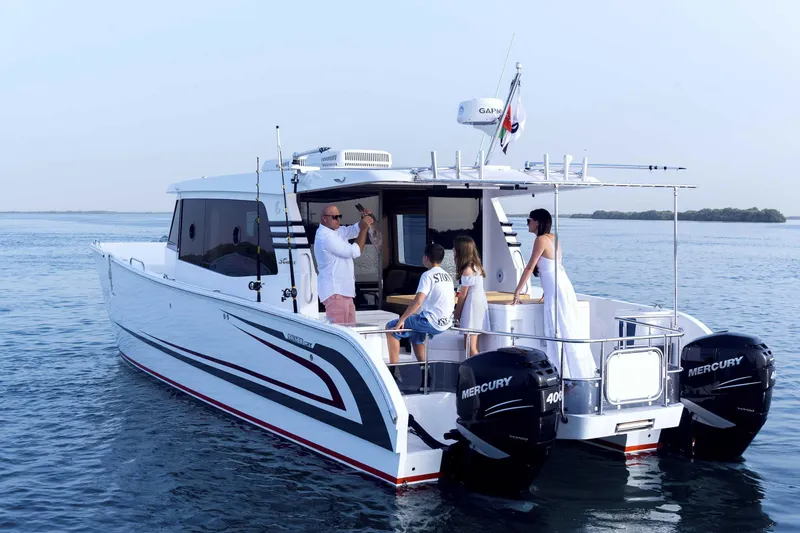 Slide: The Image of 2026 SilverCAT 40LUX boat on water with people enjoying a sunny day. - 2