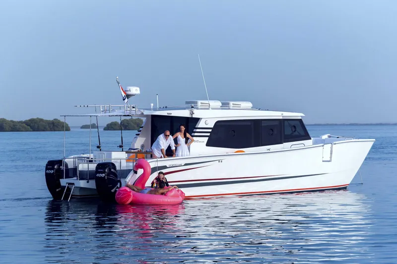 Slide: The Image of SilverCAT 40LUX yacht on water with people and pink flamingo float, 2026 model. - 5