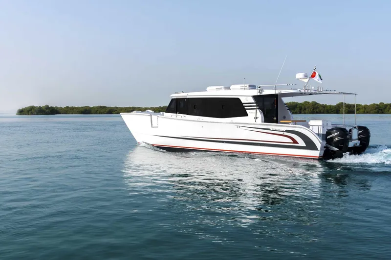 Slide: The Image of 2026 SilverCAT 40LUX boat cruising on calm water with lush greenery in the background. - 6