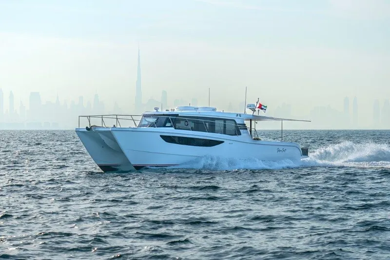 Slide: The Image of Luxury SilverCAT 46LUX yacht cruising on open sea, city skyline in background, 2026 model. - 4