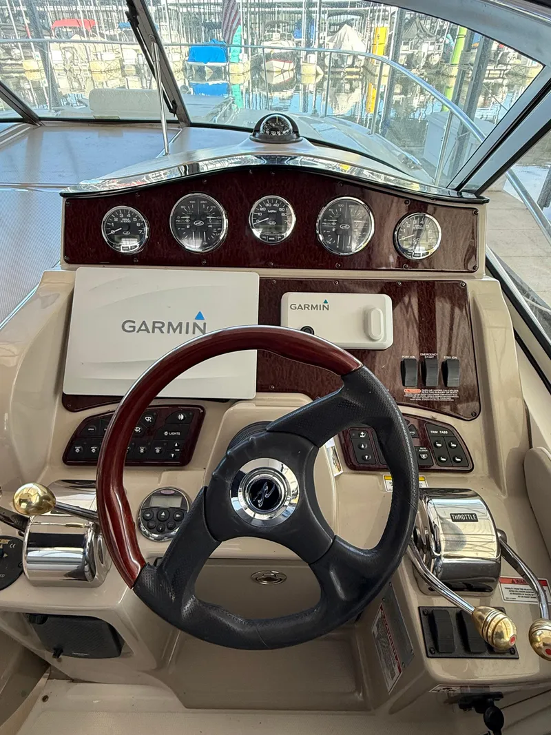 Slide: The Image of 2007 Sea Ray 310 Sundancer helm with Garmin navigation system and classic wood finish. - 11