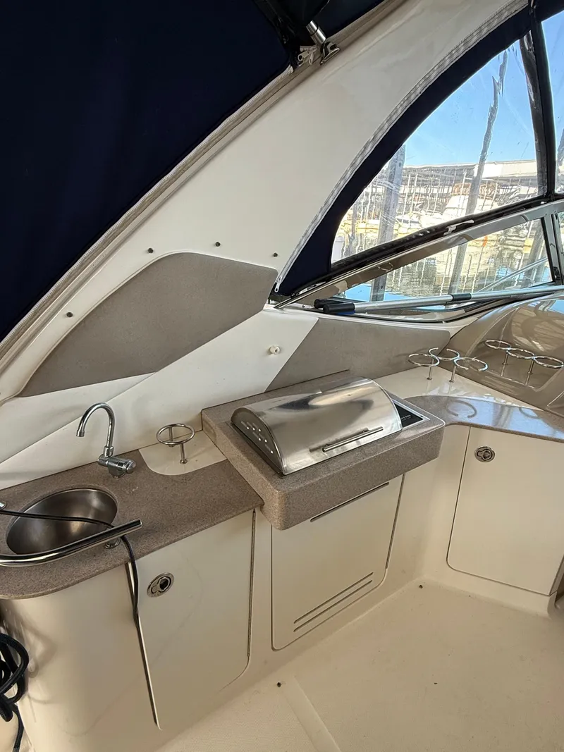 Slide: The Image of 2007 Sea Ray 310 Sundancer boat interior with kitchenette and sink. - 13