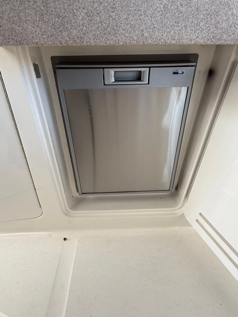 Slide: The Image of 2007 Sea Ray 310 Sundancer interior with built-in stainless steel refrigerator. - 15