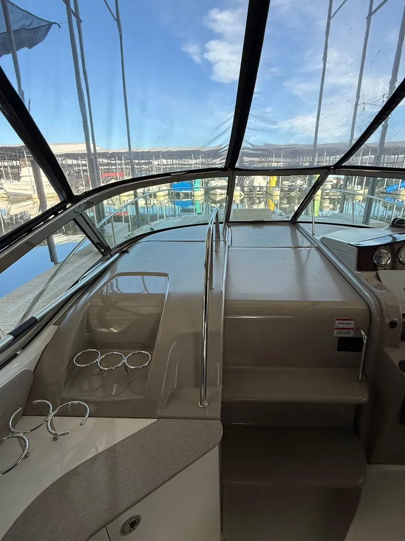 Slide: The Image of Interior view of 2007 Sea Ray 310 Sundancer boat with marina background. - 16