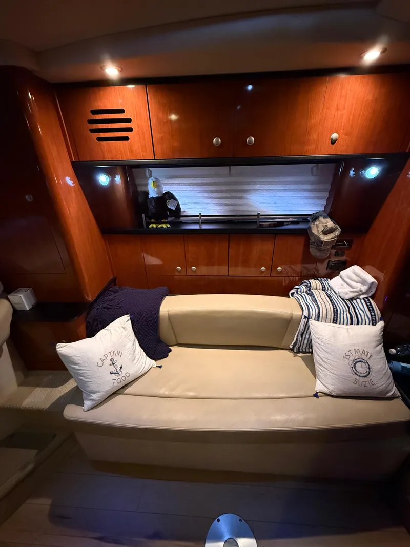 Slide: The Image of Interior of 2007 Sea Ray 310 Sundancer with cozy seating and wooden cabinetry. - 19