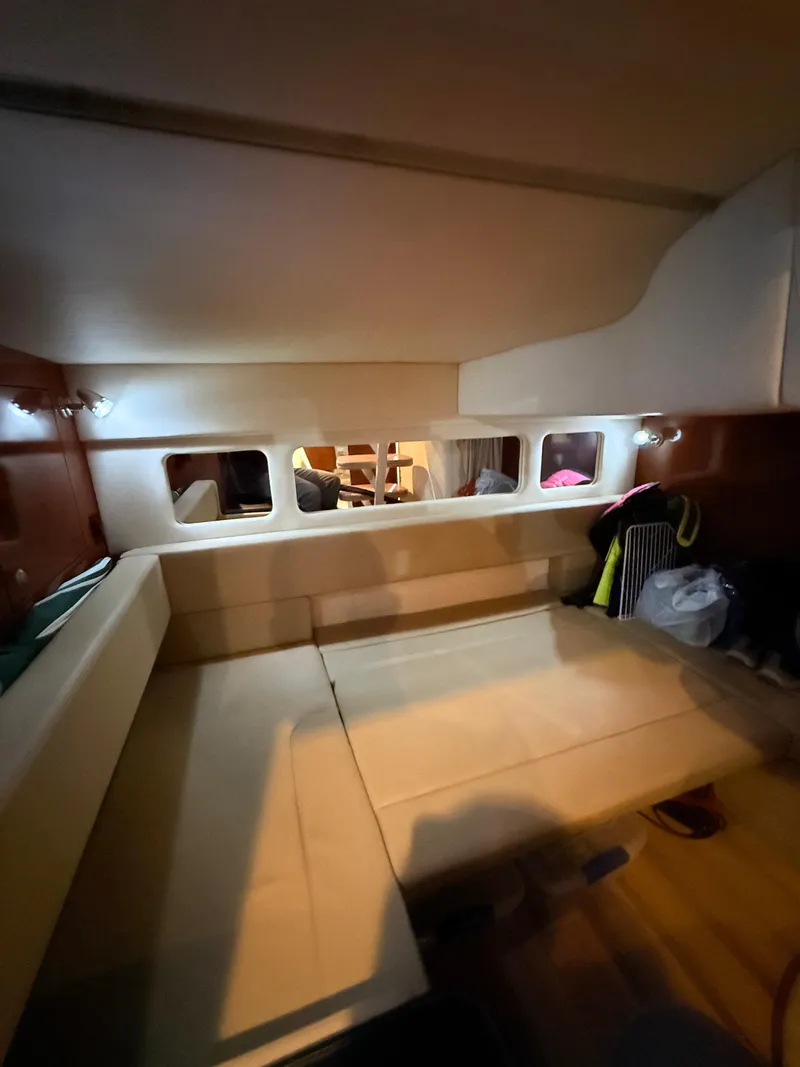 Slide: The Image of Interior of 2007 Sea Ray 310 Sundancer, featuring cozy seating and ambient lighting. - 29