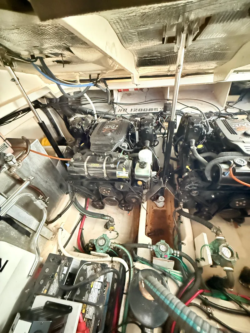 Slide: The Image of Engine compartment of a 2007 Sea Ray 310 Sundancer boat, showcasing dual engines and wiring. - 31
