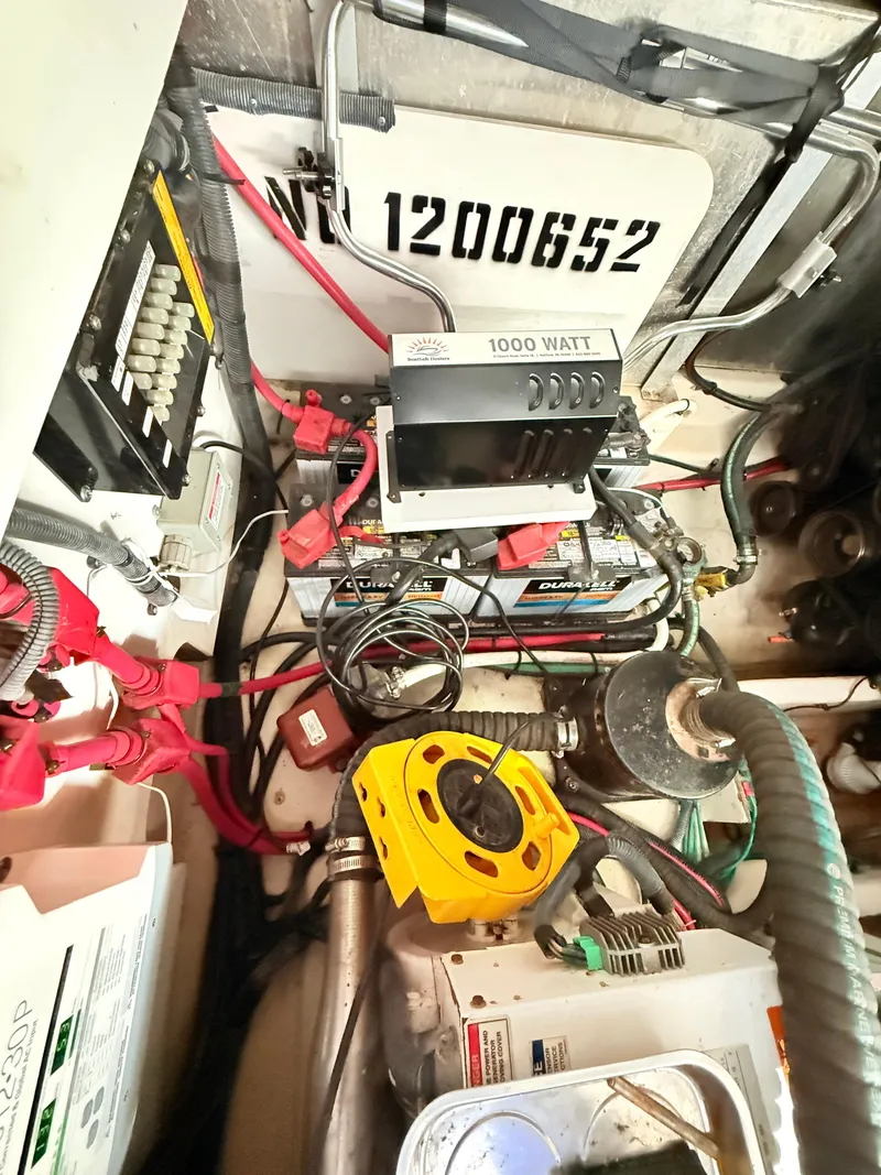 Slide: The Image of Engine room of 2007 Sea Ray 310 Sundancer with electrical components and wiring. - 32