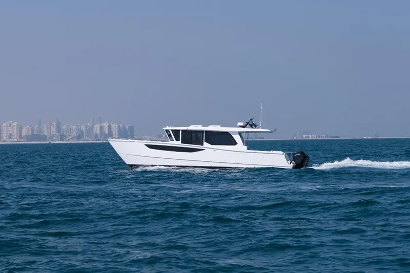 Slide: The Image of SilverCAT 46WA 2026 model cruising on open water with city skyline in background. - 2