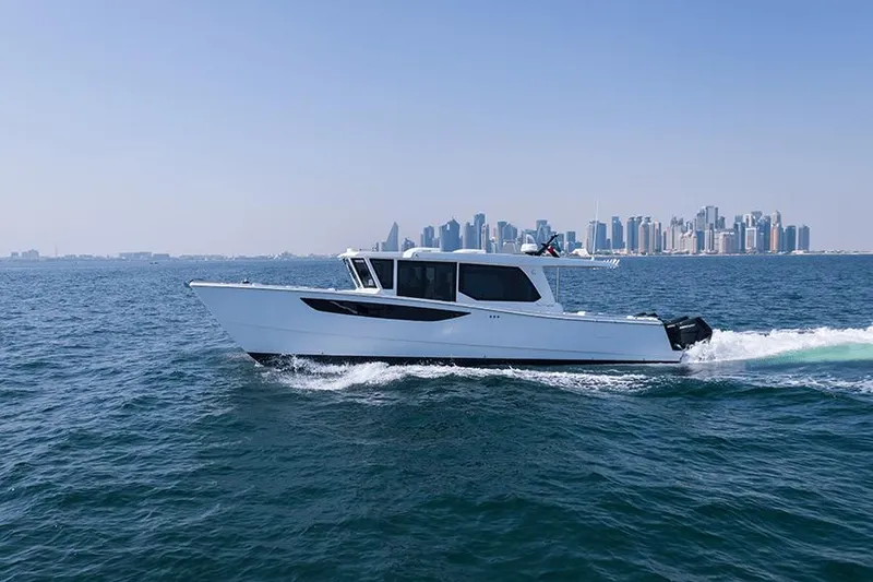 Slide: The Image of SilverCAT 46WA 2026 boat cruising on ocean with city skyline in background. - 5