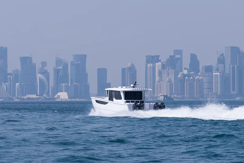 Slide: The Image of SilverCAT 46WA boat cruising near a city skyline, 2026 model. - 6