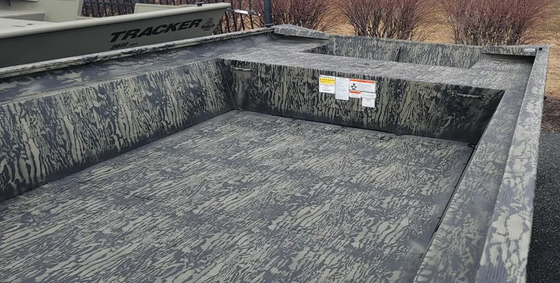 Slide: The Image of 2025 Tracker Grizzly 1860 Jon boat with camouflage interior design. - 2