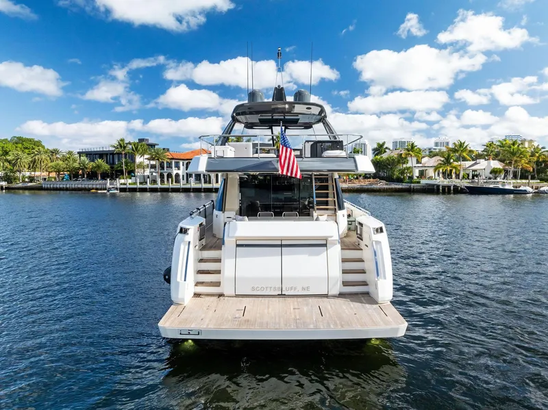 Slide: The Image of 2019 Ferretti Yachts 780 on water, rear view, sunny day, American flag displayed. - 11