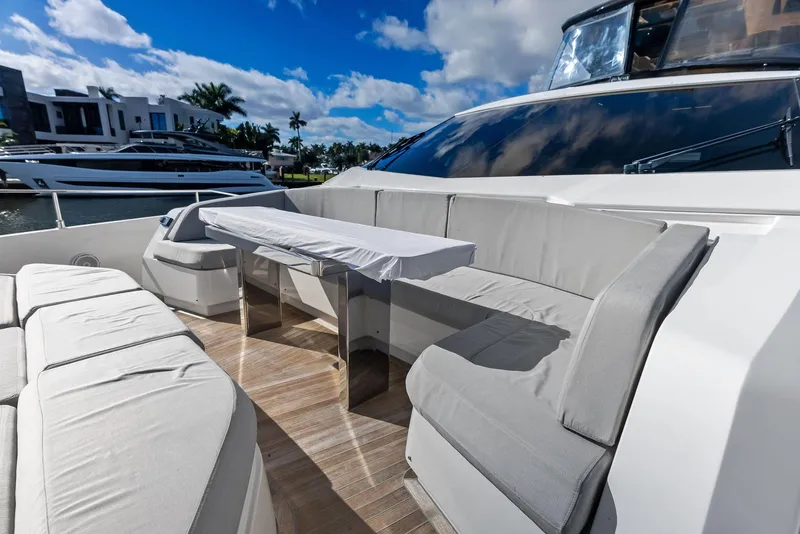 Slide: The Image of Luxurious 2019 Ferretti Yachts 780 with elegant outdoor seating and table setup. - 22