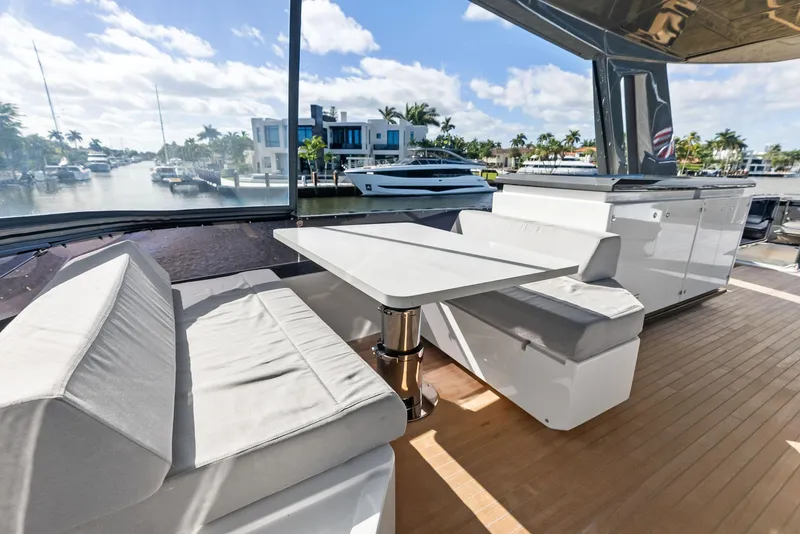 Slide: The Image of Luxurious 2019 Ferretti Yachts 780 deck with elegant seating and scenic marina view. - 31