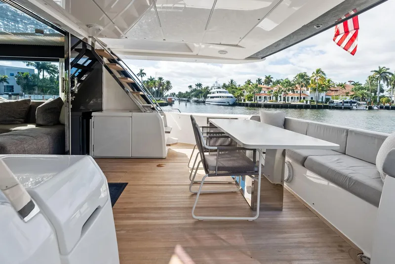Slide: The Image of Luxurious 2019 Ferretti Yachts 780 deck with seating, table, and scenic waterfront view. - 41