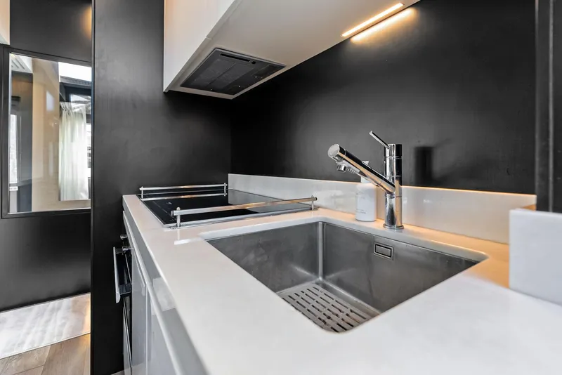 Slide: The Image of Modern kitchen interior on a 2019 Ferretti Yachts 780, featuring sleek sink and stovetop. - 47