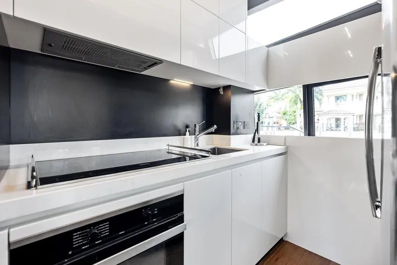 Slide: The Image of Modern kitchen interior on 2019 Ferretti Yachts 780, featuring sleek white cabinetry and appliances. - 49