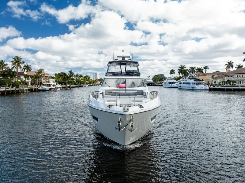 Slide: The Image of 2019 Ferretti Yachts 780 cruising on a scenic waterway under a partly cloudy sky. - 6